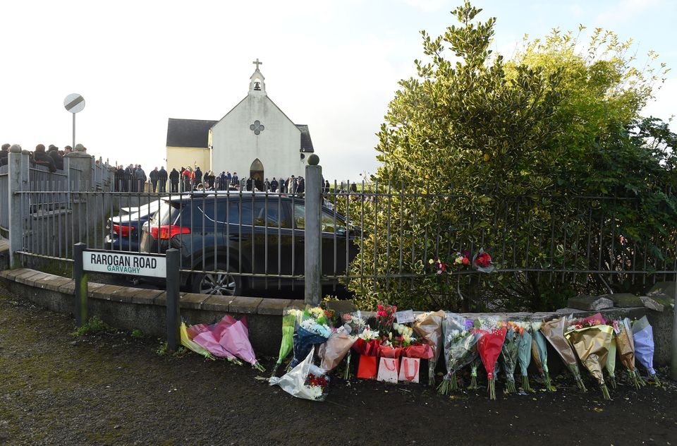 Flowers left at the scene of the road accident close to the funeral service for Nathan Corrigan, 20 (Oliver McVeigh/PA)